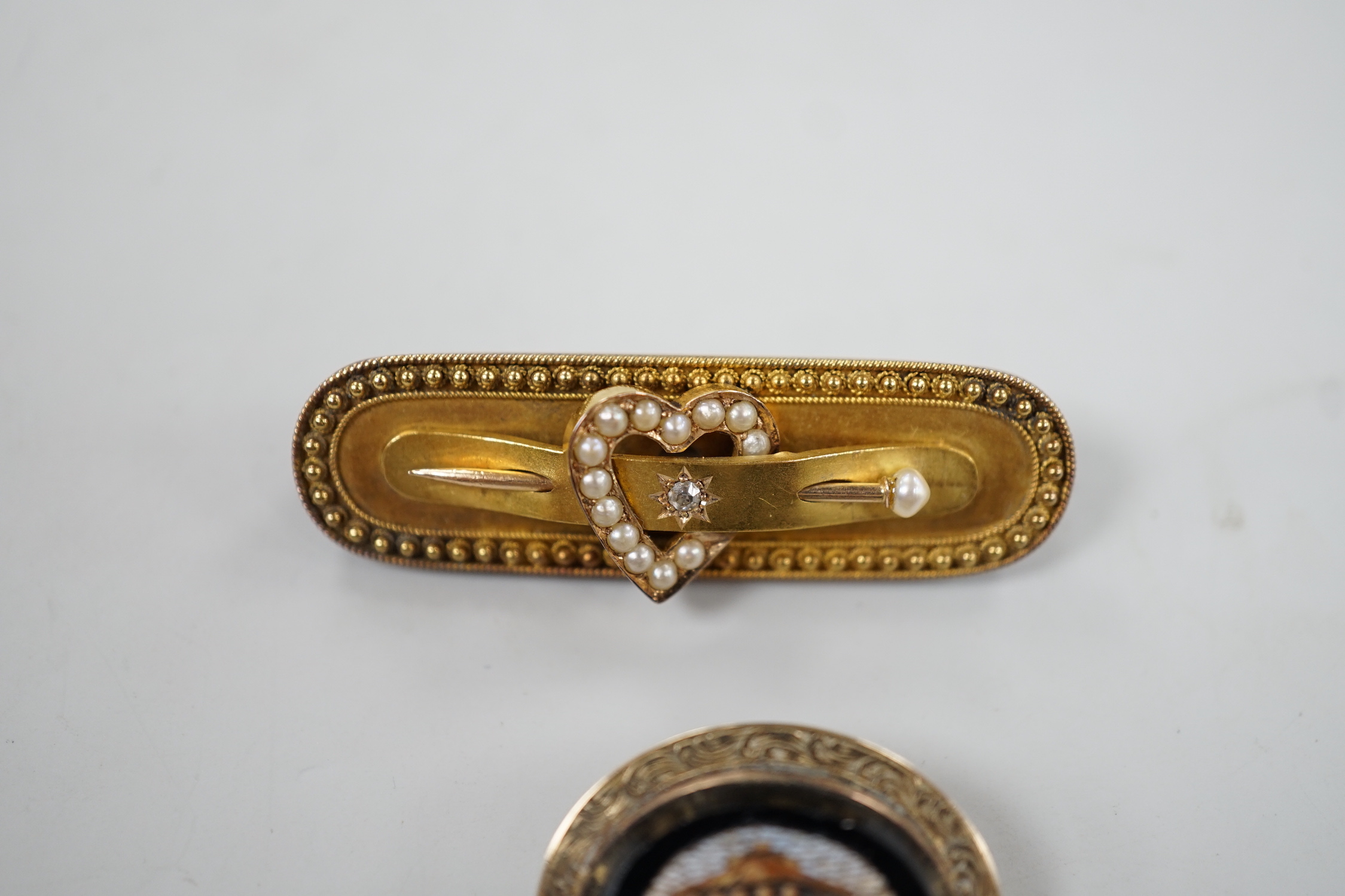 A late Victorian 15ct gold, diamond chip and seed pearl set heart and pin bar brooch, 44mm, gross weight 6.2 grams and a Victorian yellow metal and micro mosaic brooch.